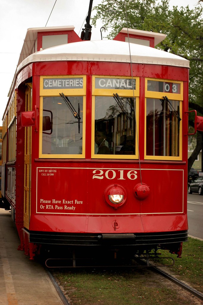 A red streetcar at the Cemeteries stop at the end of Canal Street